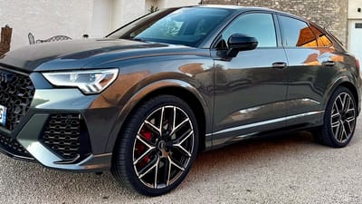 Audi RS Q3 in Grau Metallic mit roten Bremssätteln und schwarzen Original-Felgen im Y-Speichen-Design